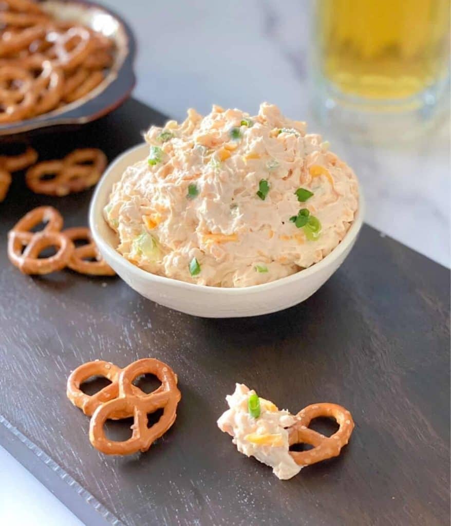 Cheddar cheese beer dip with pretzel dippers on the side