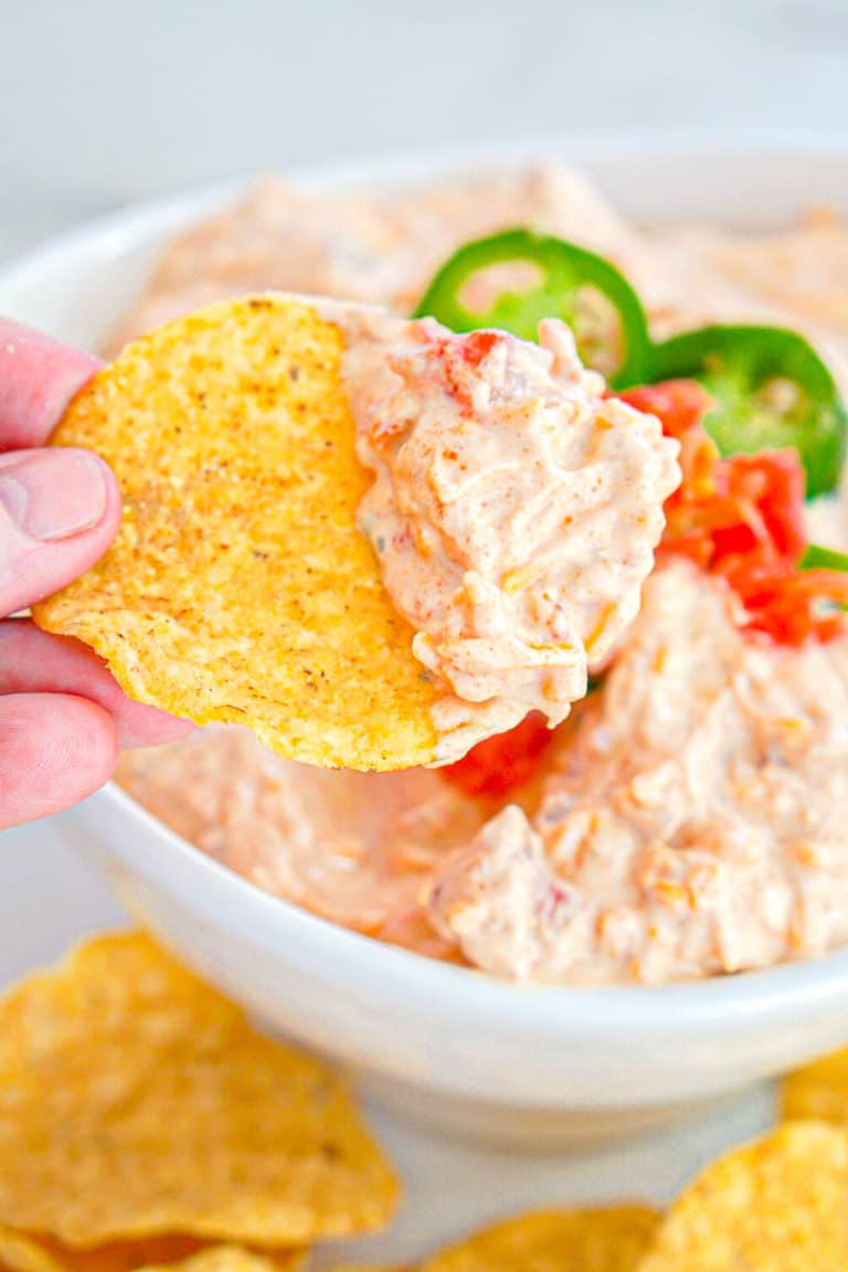 four ingredient taco dip being scooped up with a tortilla chip