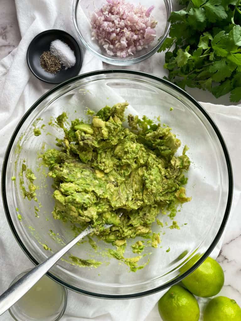 mashed avocado in a clear bowl