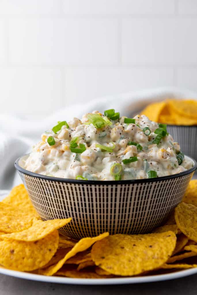 finished corn dip recipe with tortilla chips on the side