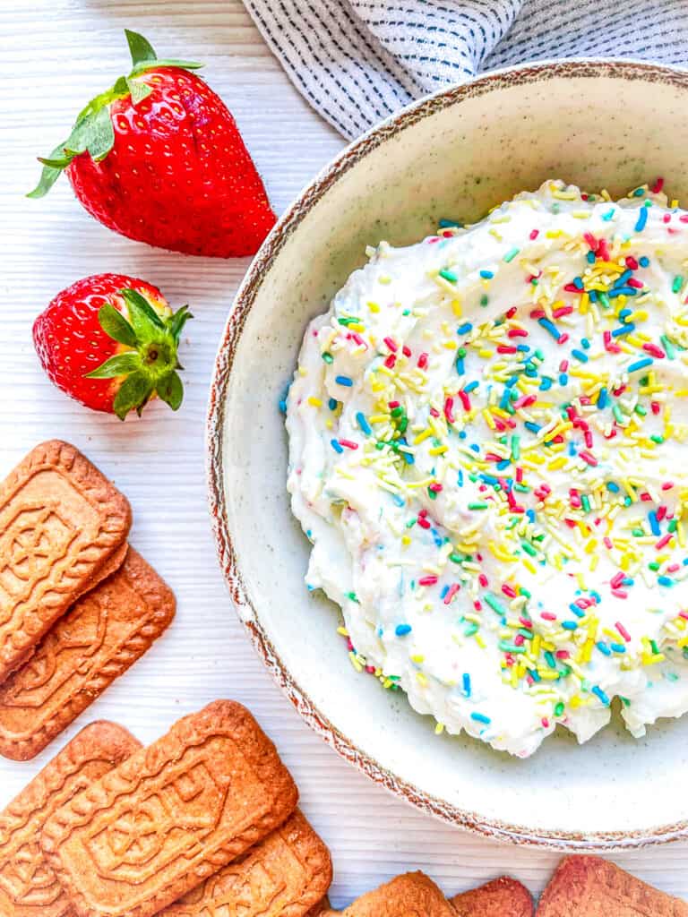 funfetti cake dip in a bowl with jimmies sprinkles