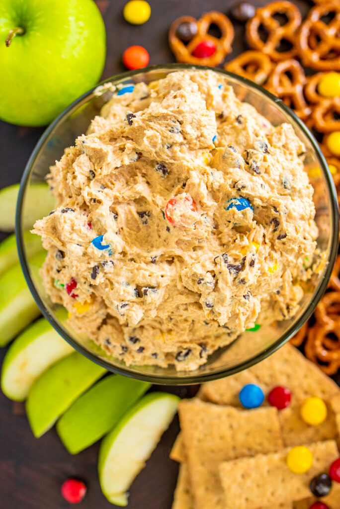 overhead photo of monster cookie dough dip with a variety of dippers on the side