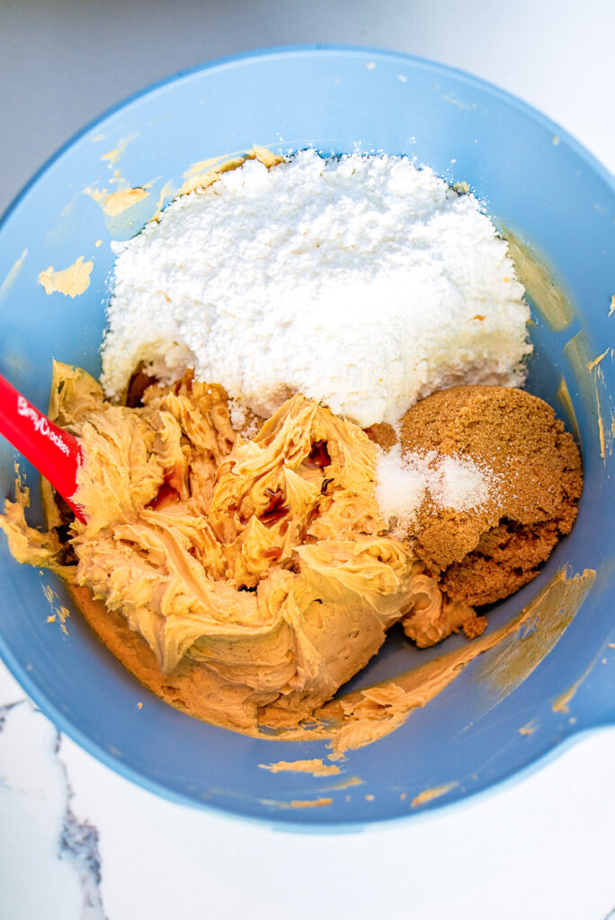 mix monster cookie dough dip ingredients in a mixing bowl with hand or stand mixer