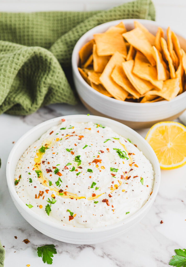 whipped feta ready for a party with a side of pita chip dippers