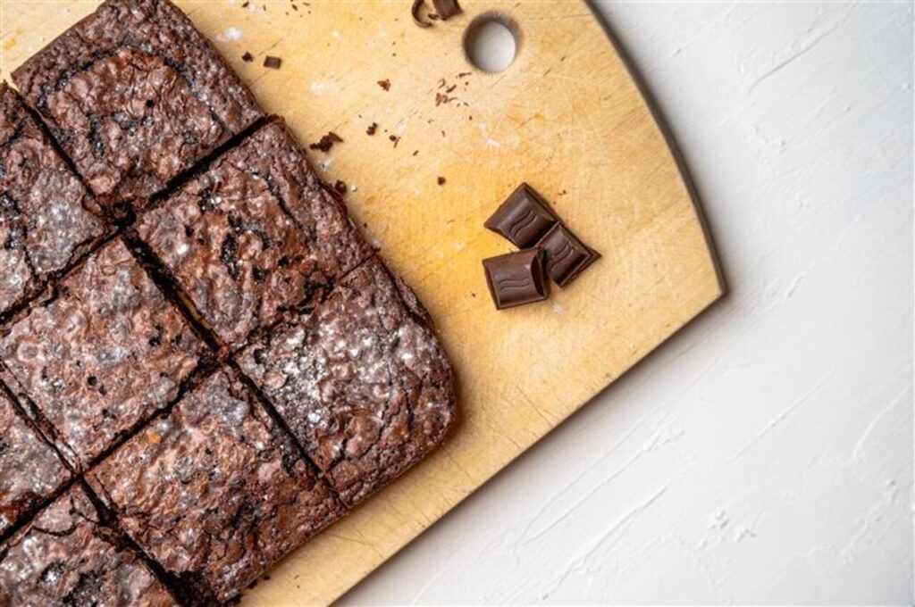 Freshly baked brownies topped with flaky sea salt crystals.