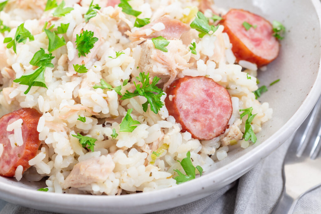 Traditional South Carolina chicken bog dish with smocked sausages, in a bowl, horizontal, closeup