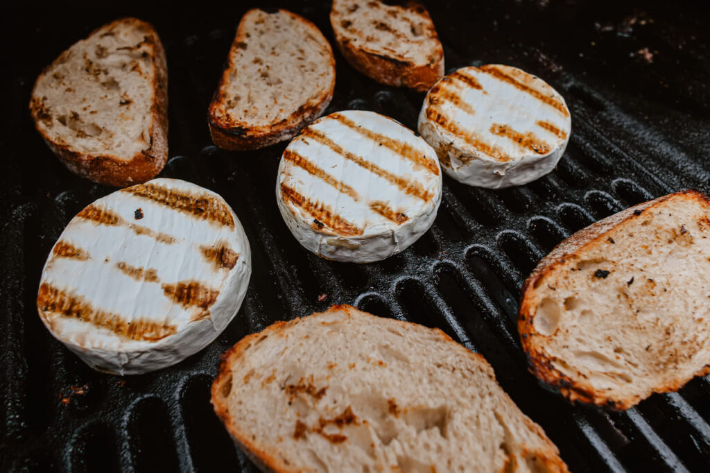 Grilled camembert, on old dark grille