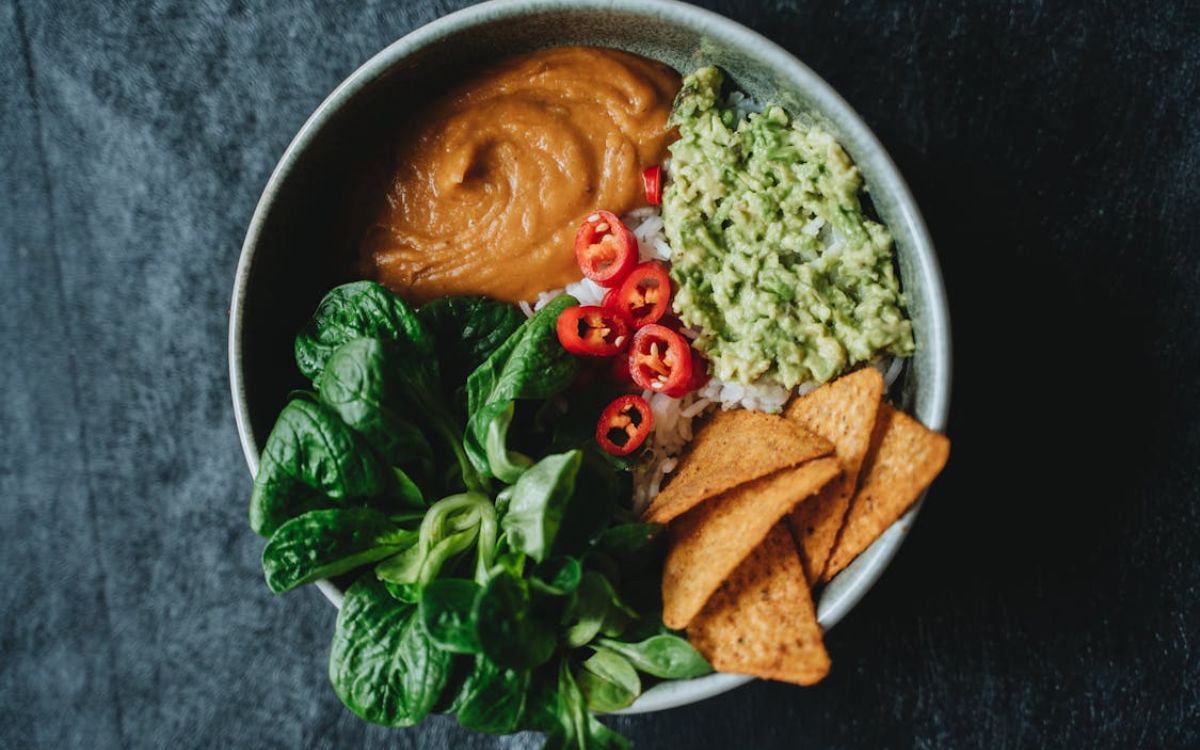 Bowl with greens, dips, and chips