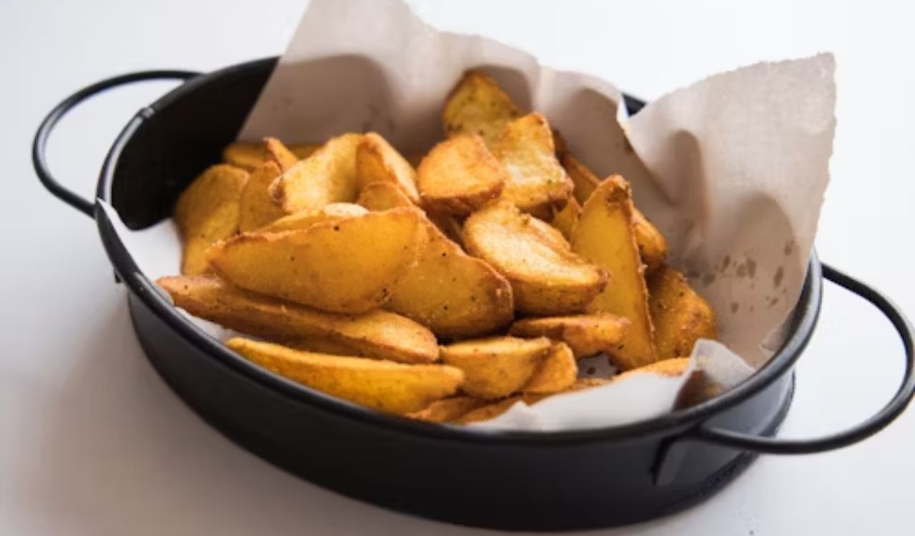A black pan filled with potato wedges