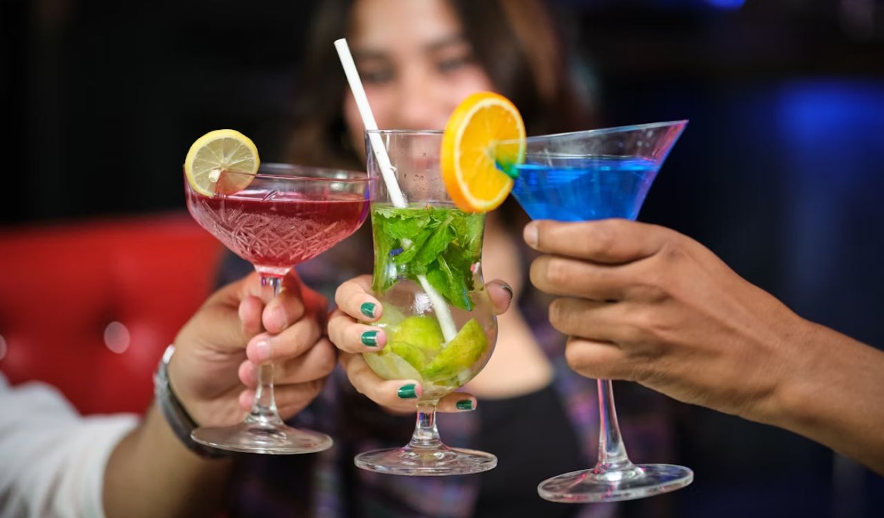 A group of people holding up wine glasses