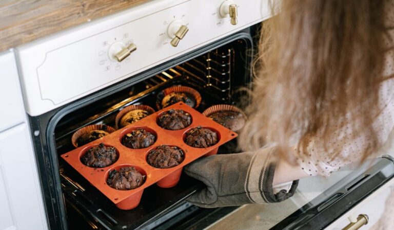 A person holding a baking tray