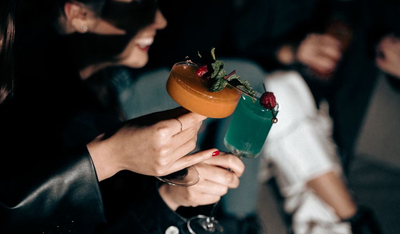 A woman holding a cocktail in her hand