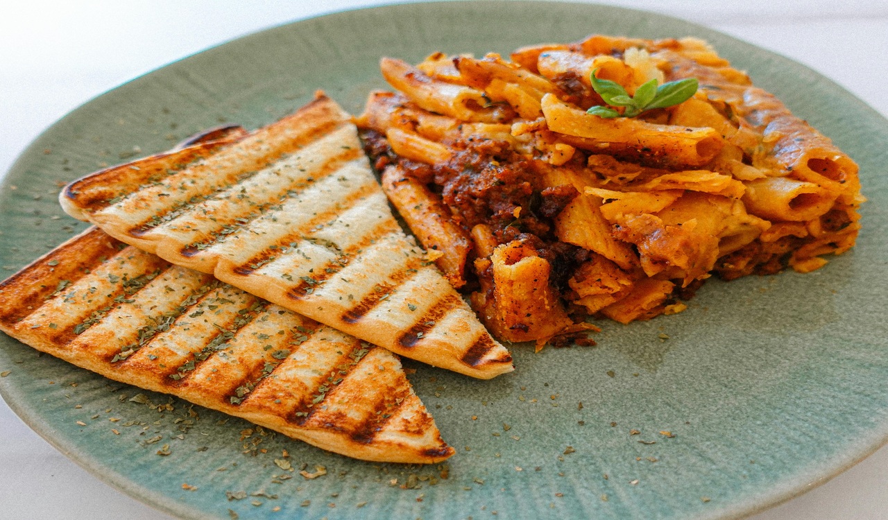Cheesy Penne Pasta on Green Plate