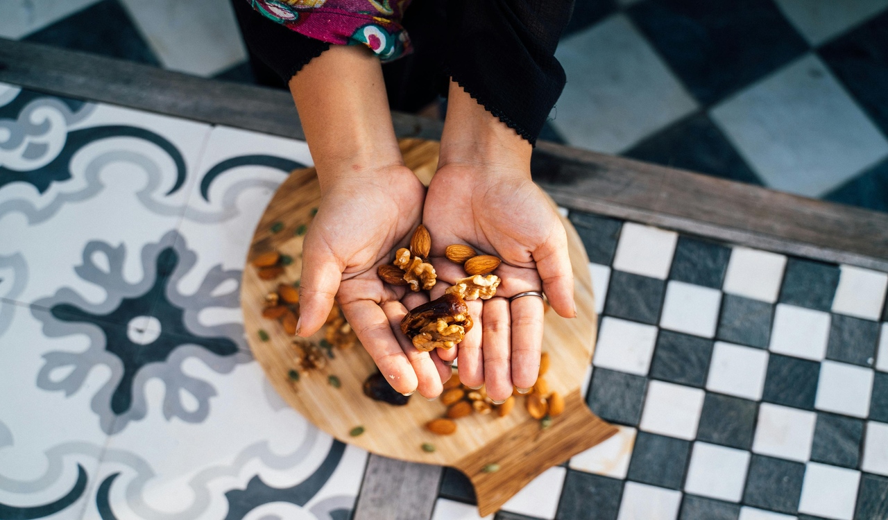 A Woman with Assorted Nuts on Her Hands