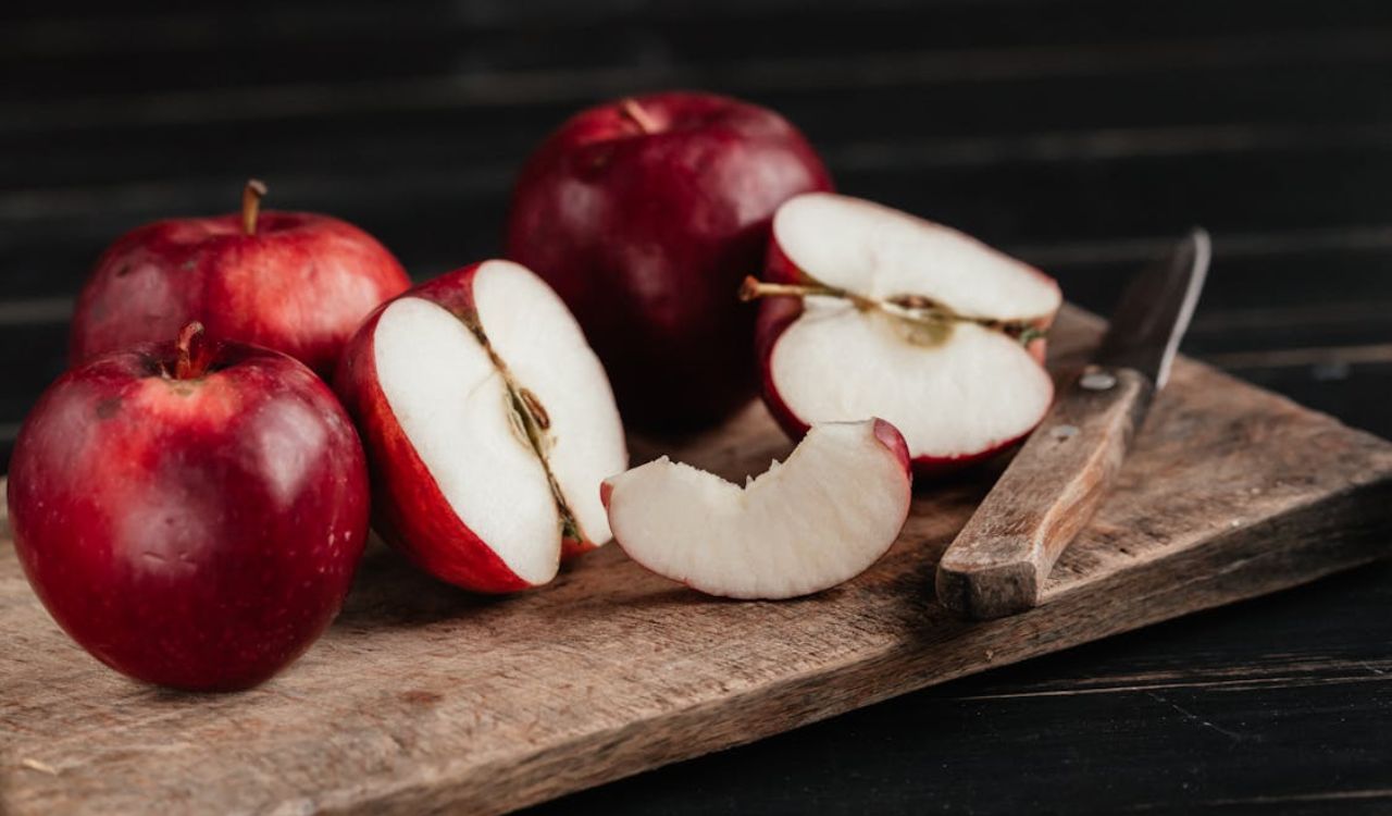 Apples and Knife on a Wooden Board