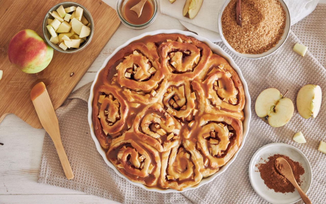 Baked apple cinnamon rolls drizzled with caramel sauce
