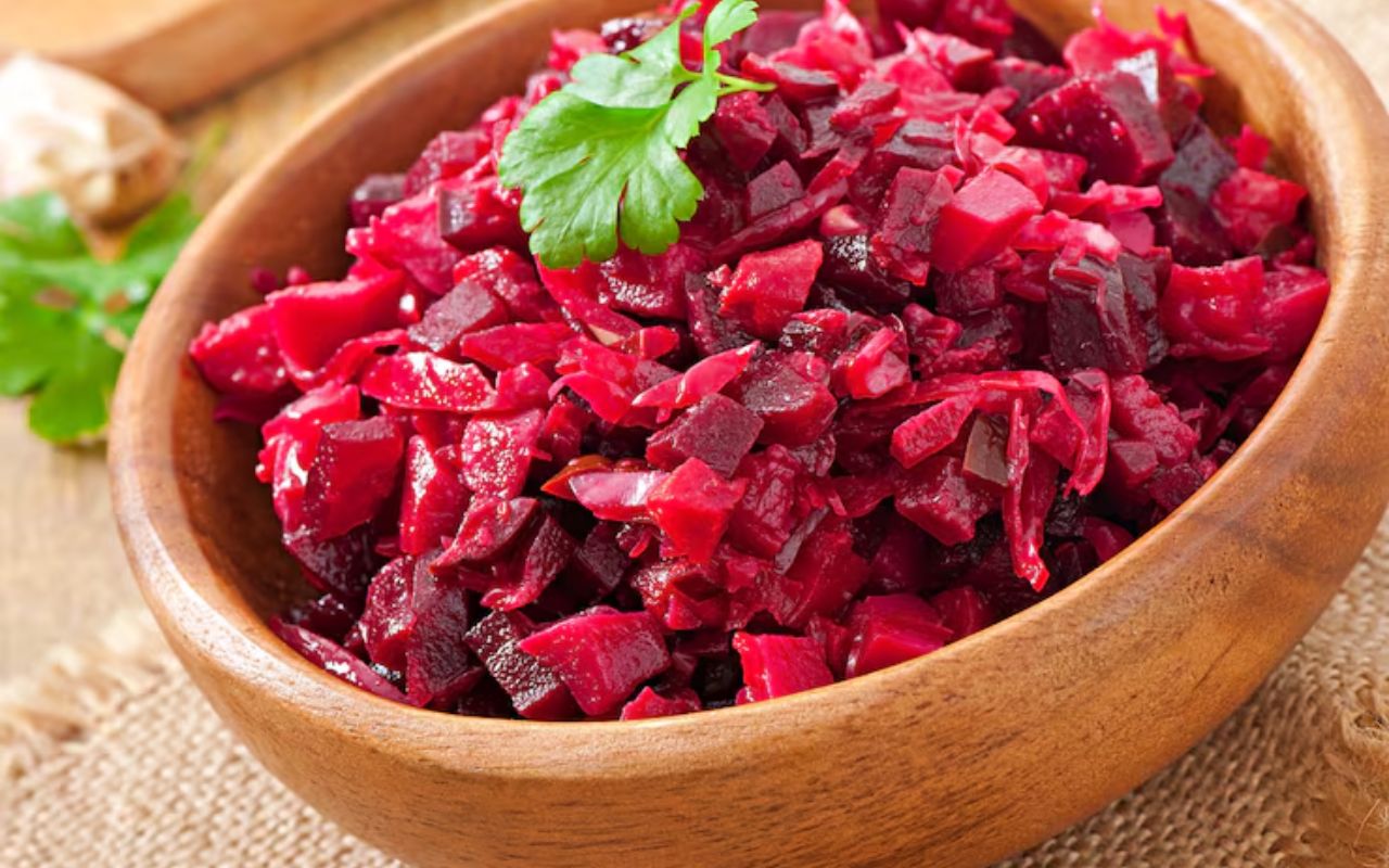 Chopped beet salad in a wooden bowl