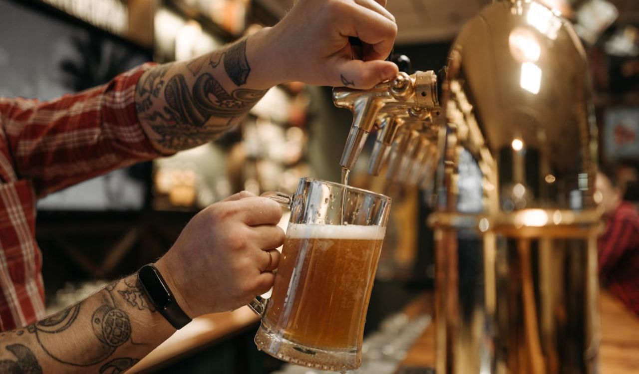 Bartender Pouring Beer into Pint Glass