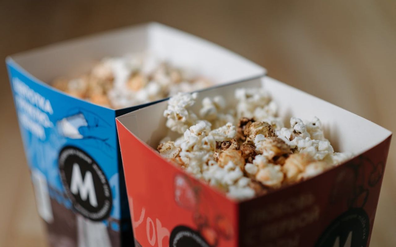 Two boxes of popcorn with seasoning