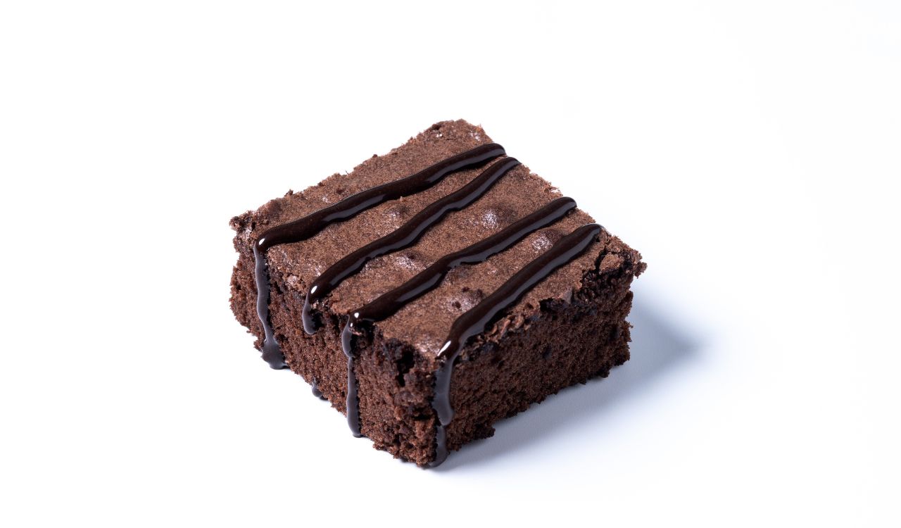 Chocolate brownie portion isolated on white background