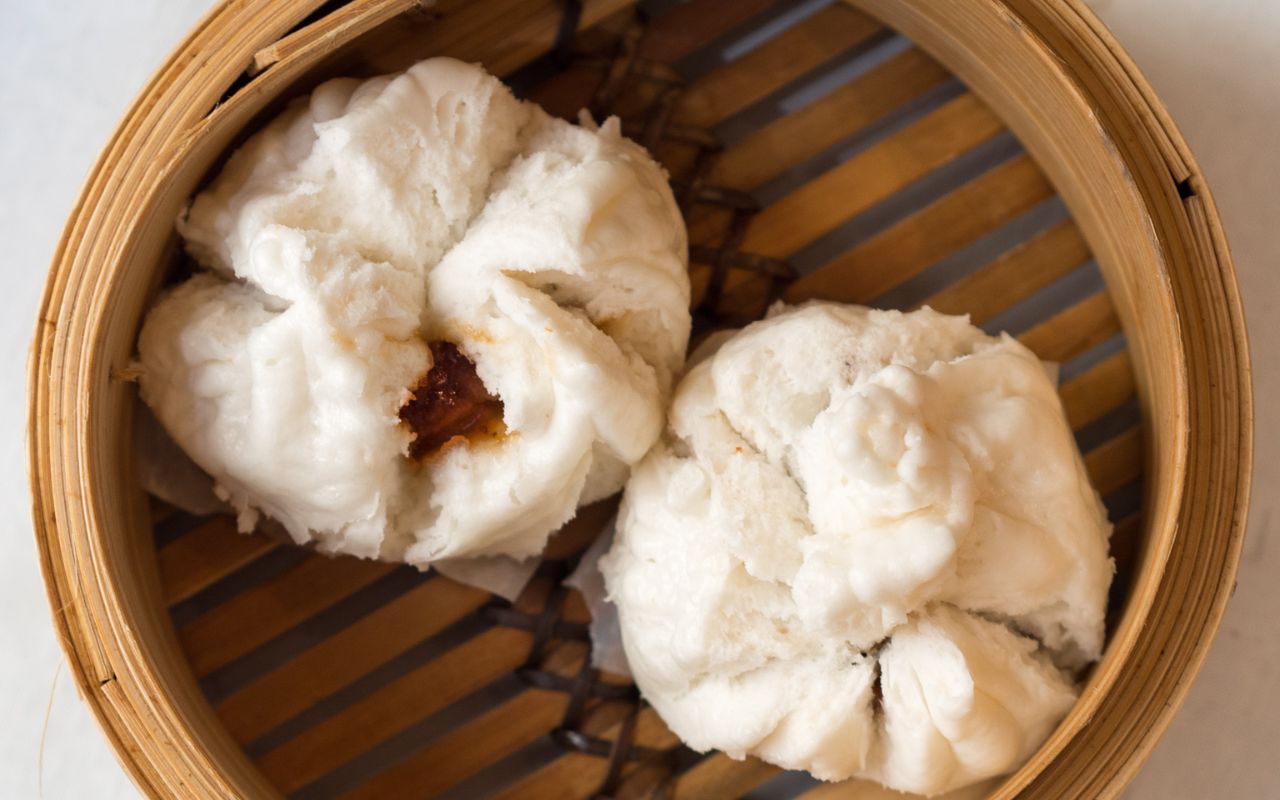 Steamed pork buns (char siu) in bamboo steamer