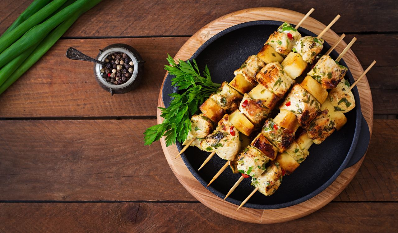 Chicken skewers with slices of apples and chili. top view