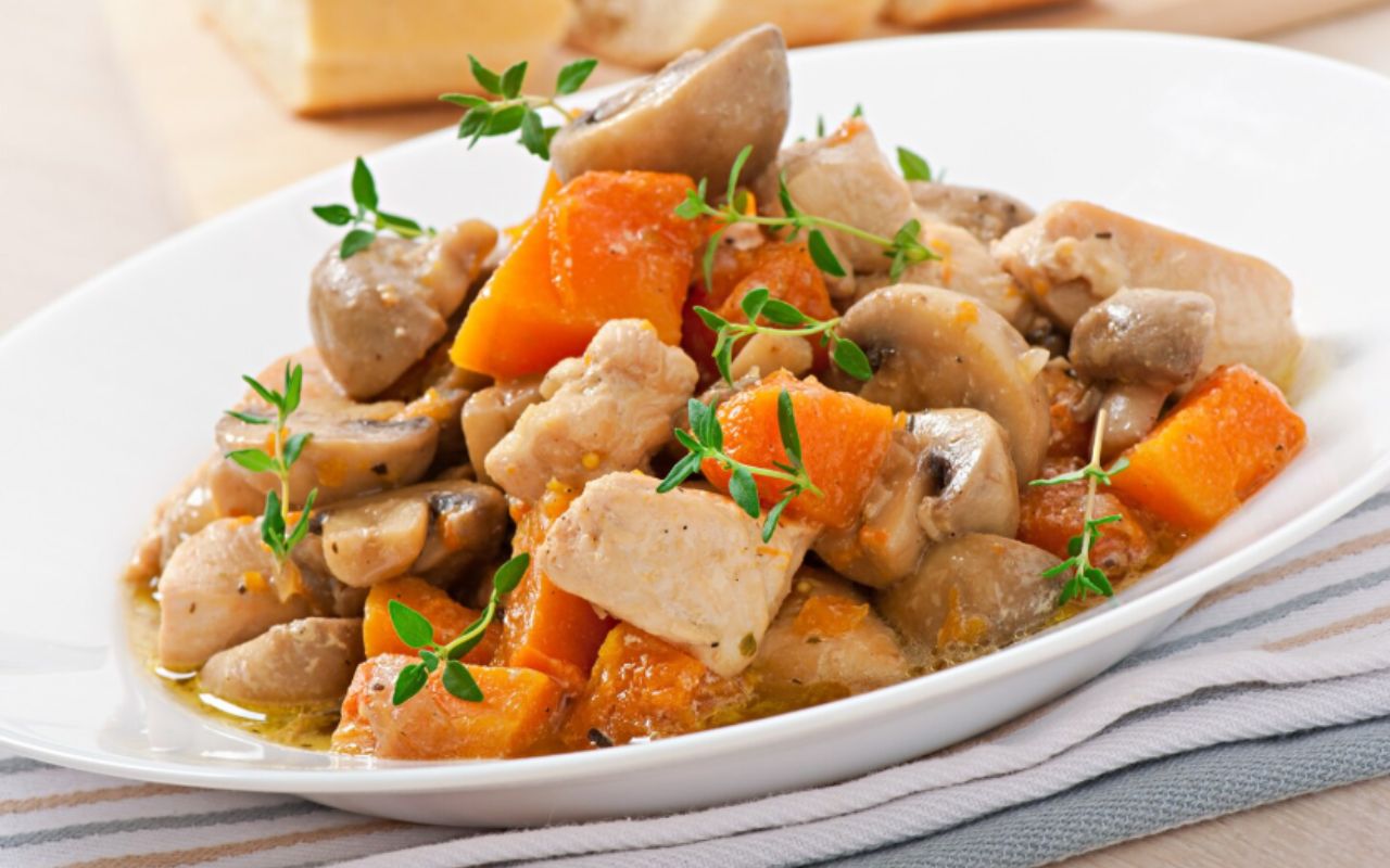 Stew chicken with vegetables and mushrooms in a cream sauce