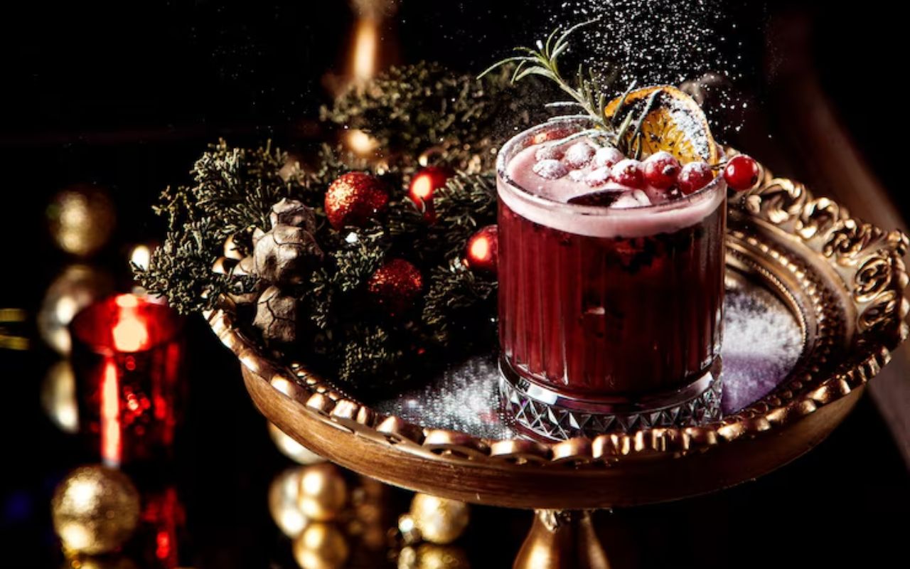 Festive cranberry cocktail with rosemary on a gold tray