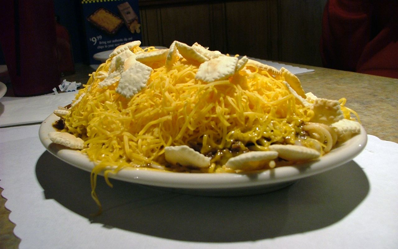 Cincinnati chili topped with shredded cheese and oyster crackers