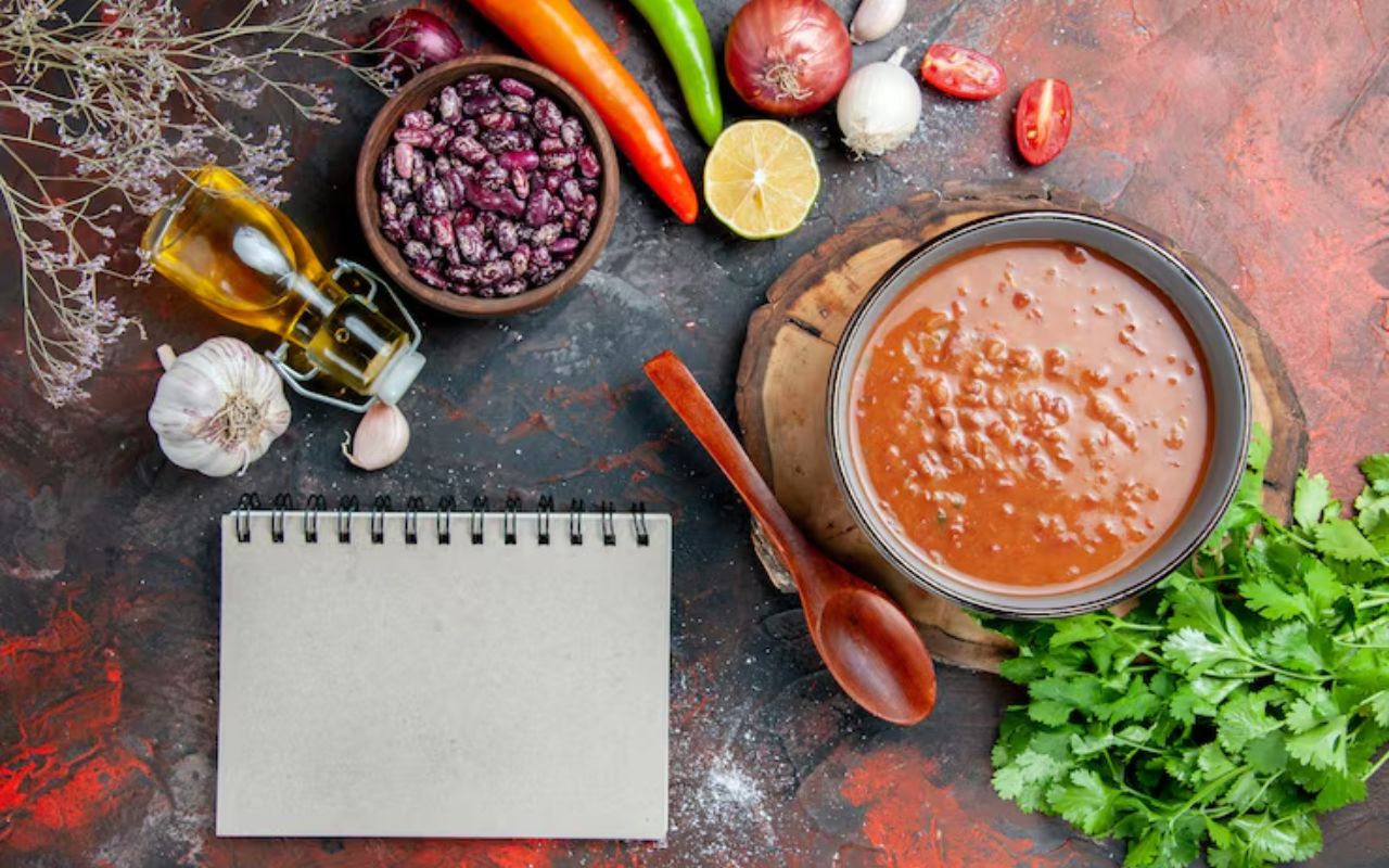 Bowl of chili with surrounding ingredients