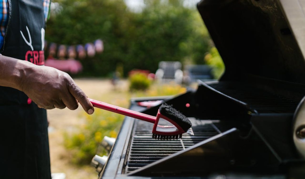 Person Cleaning the Griller