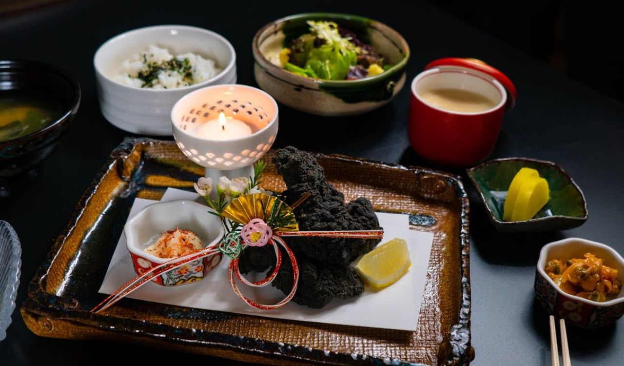 Close-up of a Gourmet Dish Served on a Tray with a Candle