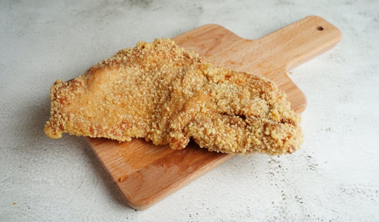 Close-up of pork chop on cutting board