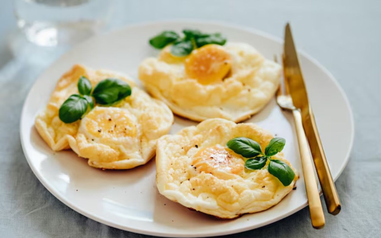 Cloud eggs with basil on plate