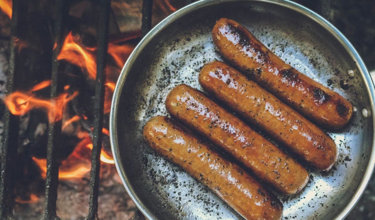 Cooked hotdogs on round grey pan