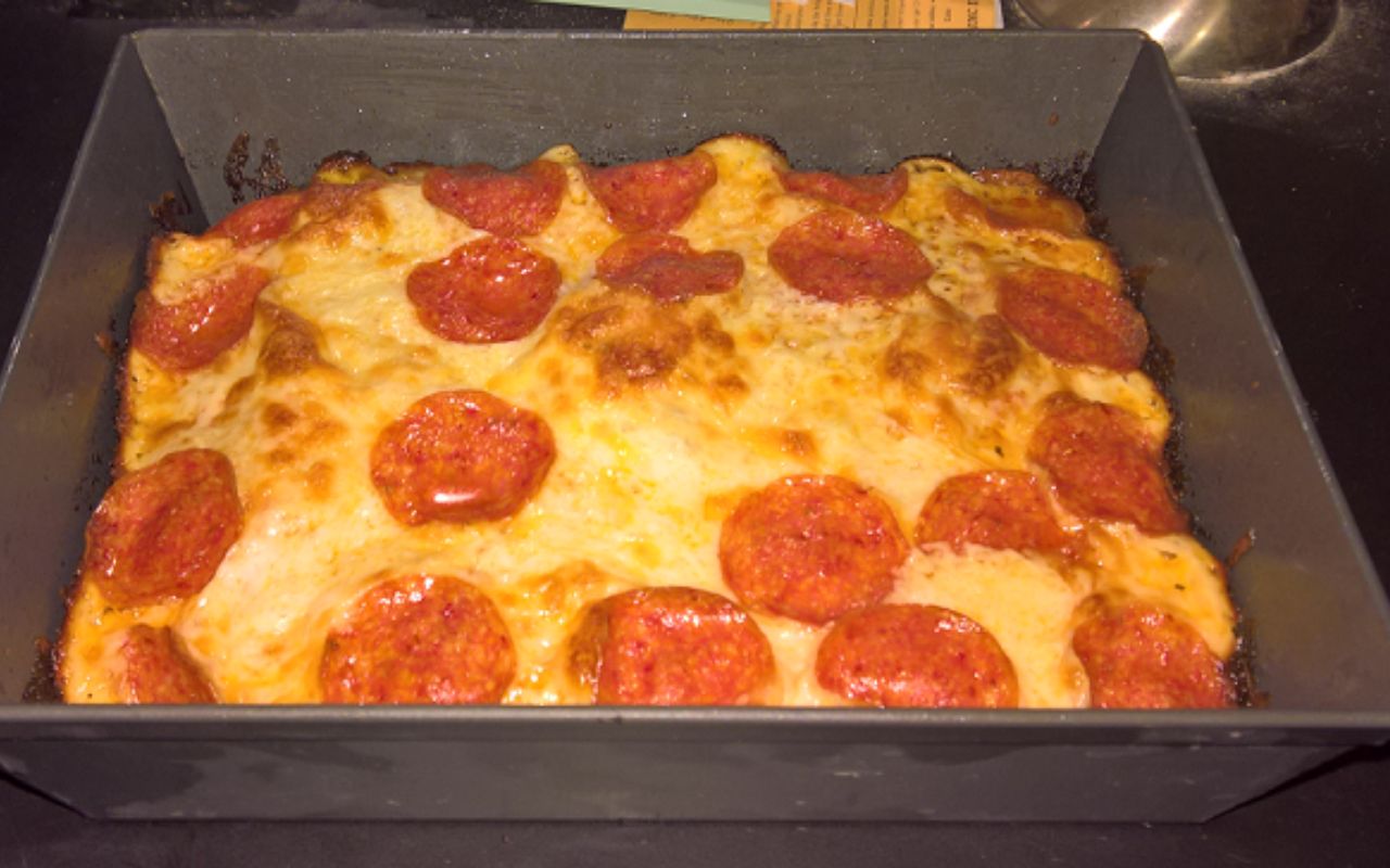 Detroit-style pepperoni pizza in a rectangular pan