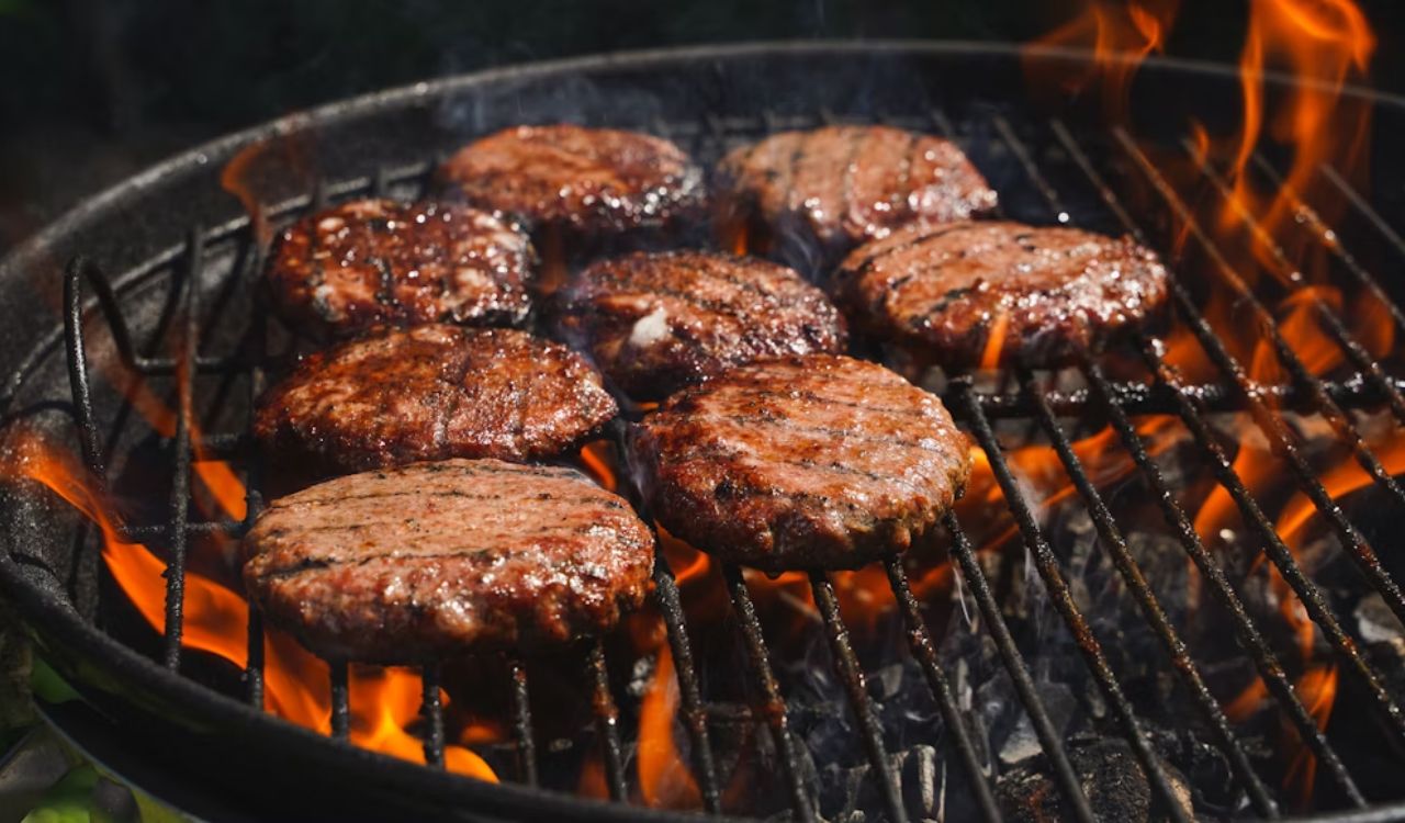 Juicy grilled beef burger cutlets on the fire