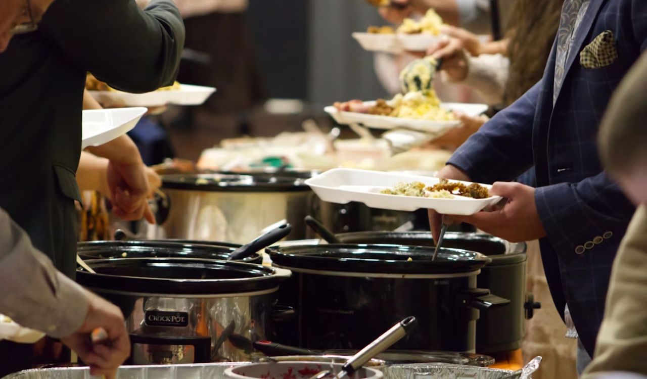 Group of people in front of crock pot slow cooker