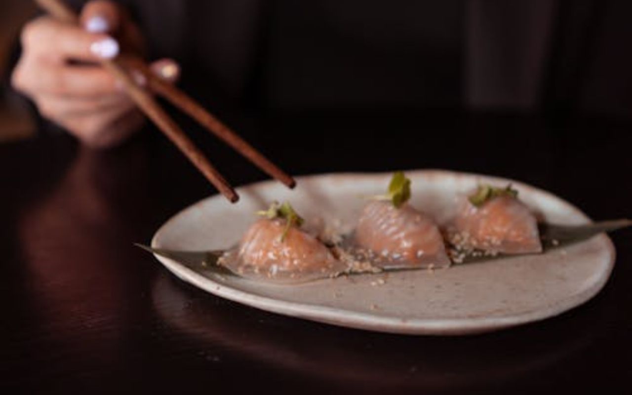 Chopsticks picking har gow shrimp dumplings