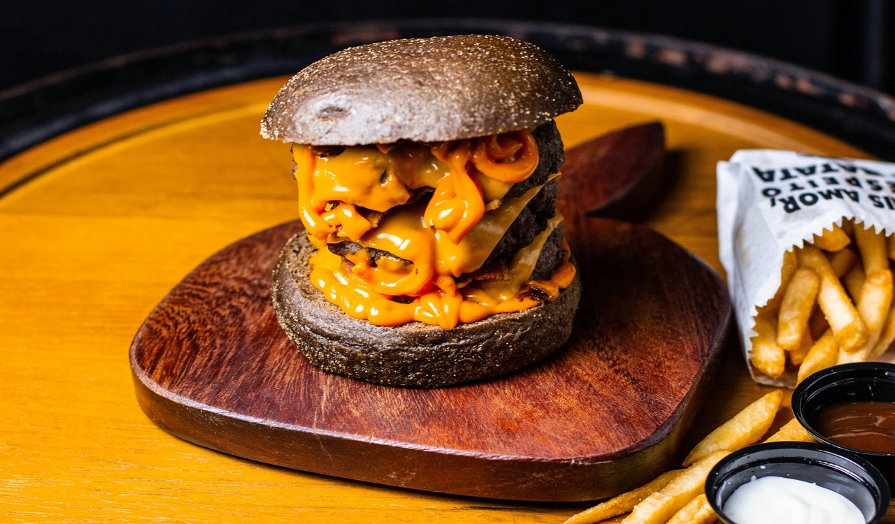 Burger With Cheese and Fries on Brown Wooden Plate