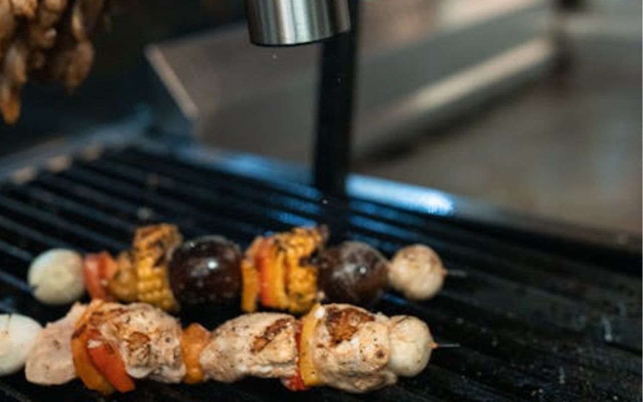 Chicken and veggie skewers on a grill