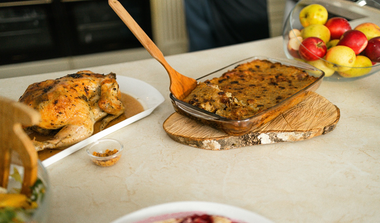 Roasted Chicken Beside Pudding on Glass Tray and Bowl of Fruits