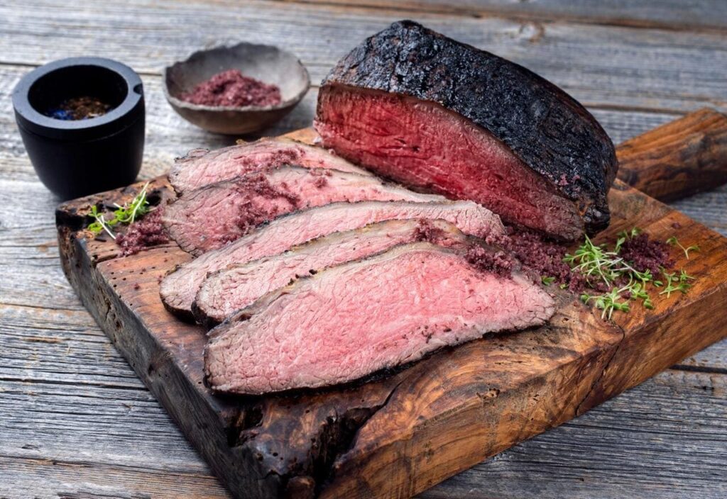 Brisket on a cutting board where the bark looks soft and slightly soggy.