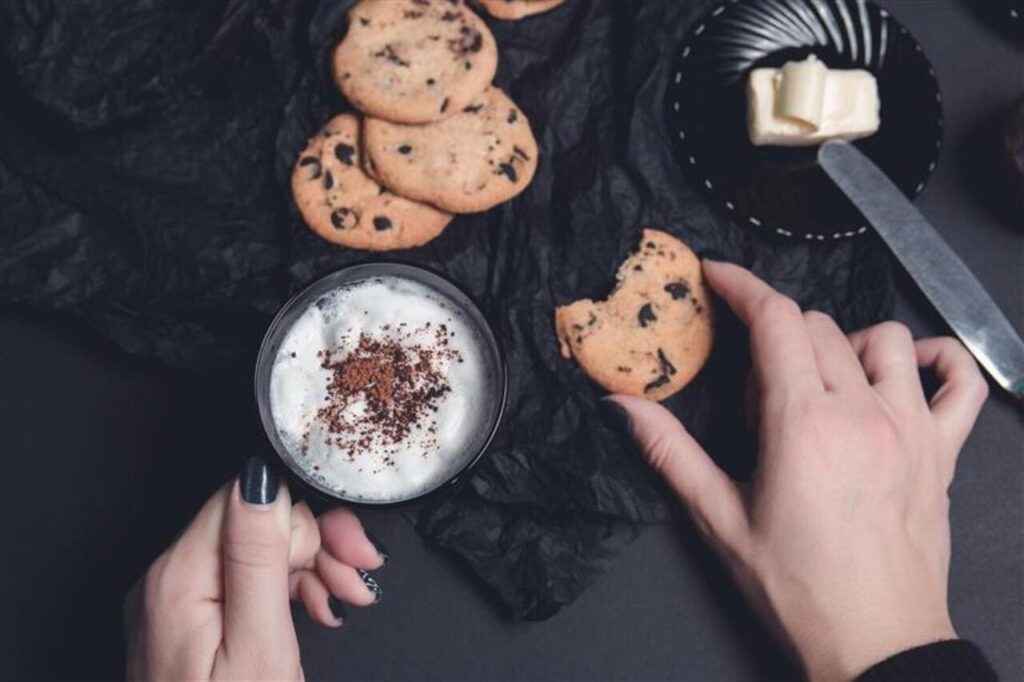 cookies and biscuits on black table background. Afternoon break time. Breakfast.