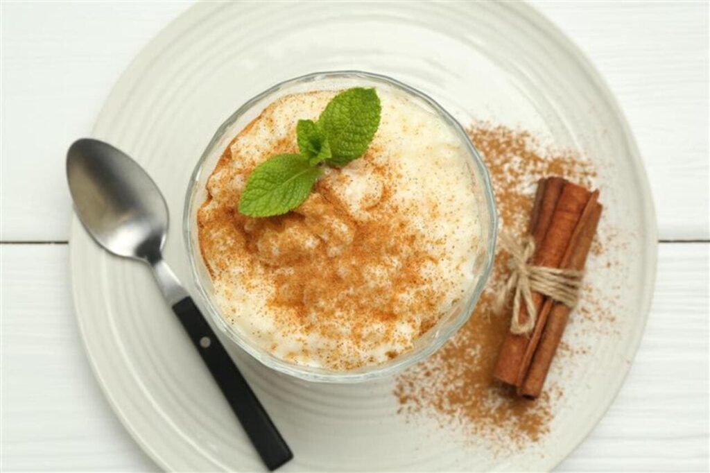 A bowl of rice pudding with cinnamon sprinkled on top.