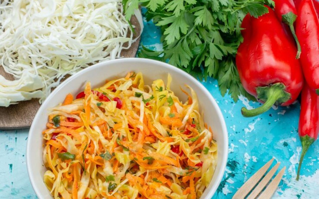 Bowl of shredded cabbage salad with carrots and peppers
