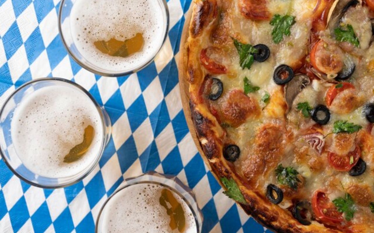 Oktoberfest pizza with beers on blue-white cloth