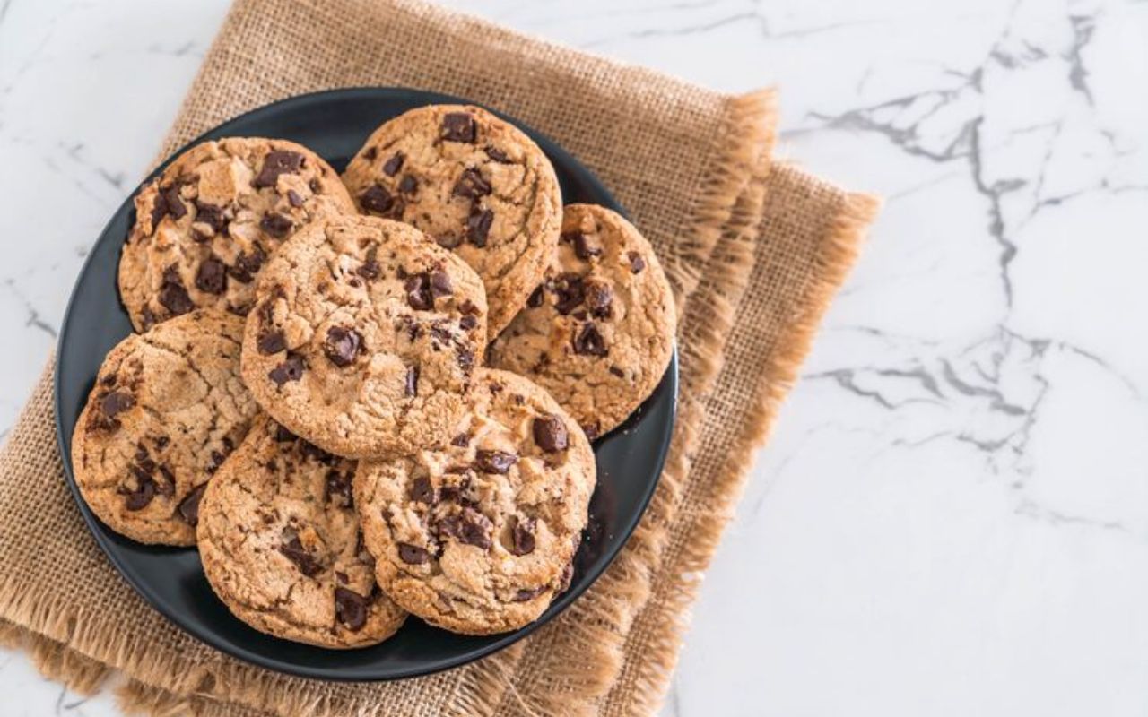 Plate of freshly baked paleo chocolate chip cookies on burlap