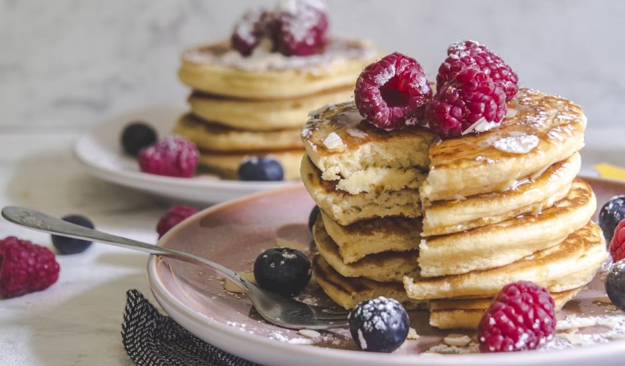 Pancakes with berries on white ceramic