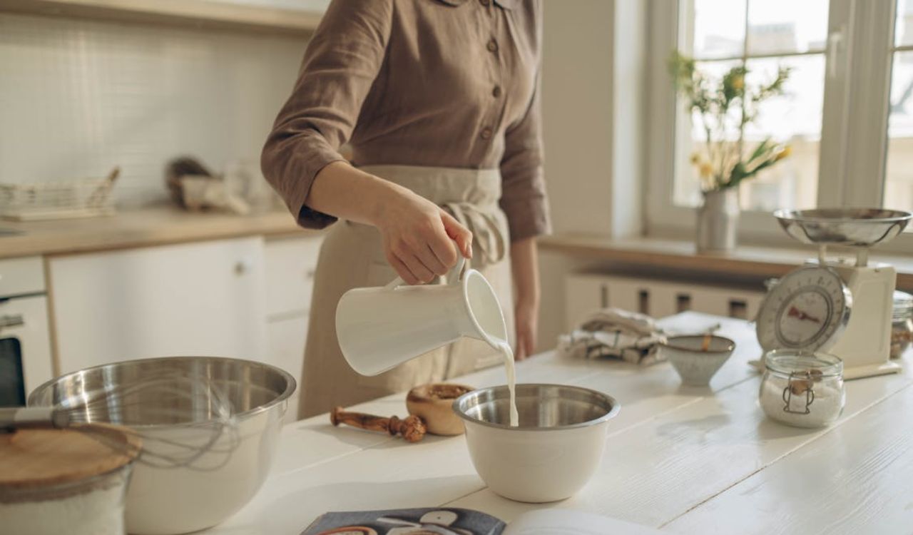 Person Pouring Milk in a Bowl